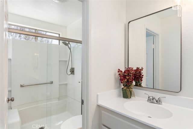 full bathroom with toilet, a shower stall, and vanity