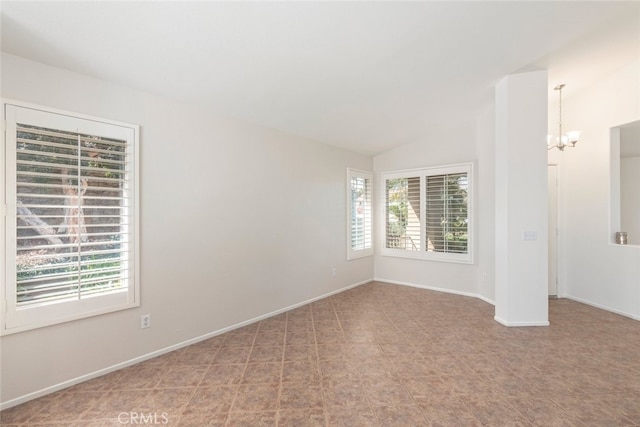 unfurnished room with lofted ceiling, an inviting chandelier, and baseboards