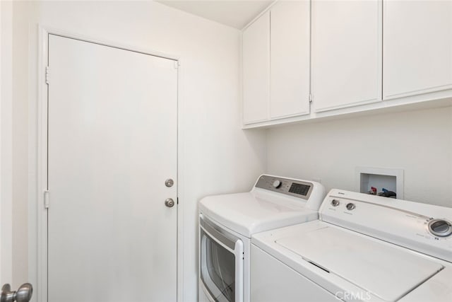 washroom with independent washer and dryer and cabinet space