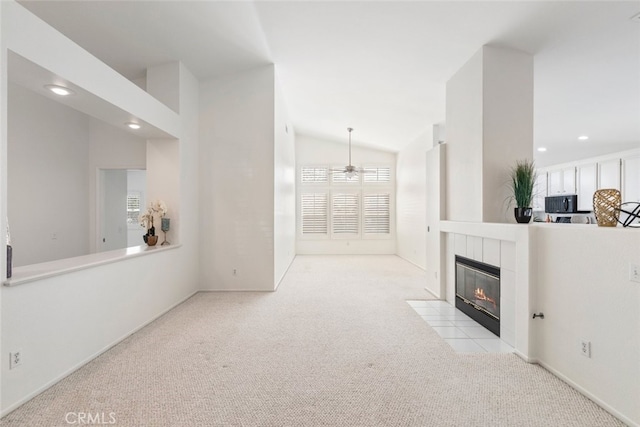 living area with recessed lighting, a tiled fireplace, a ceiling fan, carpet flooring, and vaulted ceiling