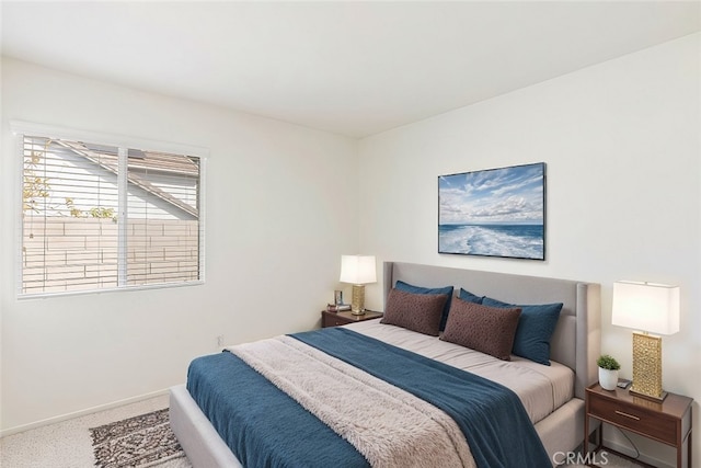 carpeted bedroom featuring baseboards