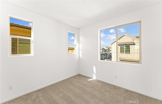 unfurnished room with light colored carpet