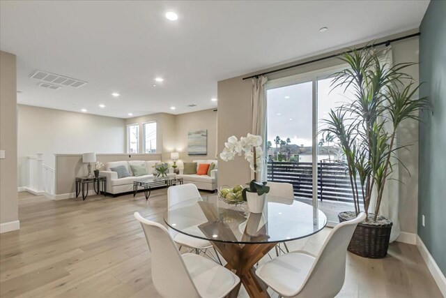 dining space featuring light wood-type flooring