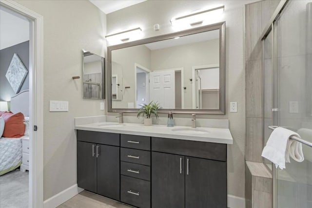 bathroom featuring hardwood / wood-style flooring, vanity, and an enclosed shower