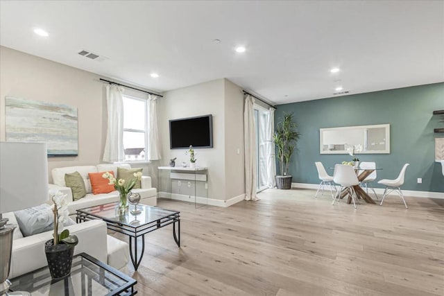 living room with light hardwood / wood-style floors