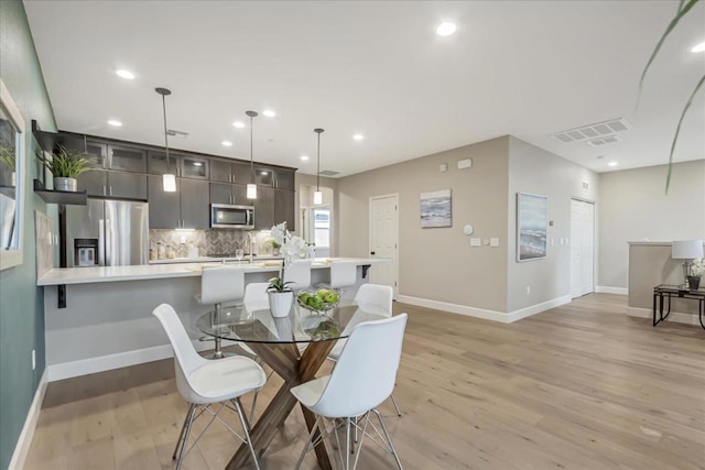 dining space with light hardwood / wood-style floors