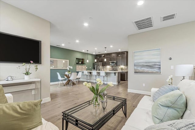 living room with light hardwood / wood-style floors