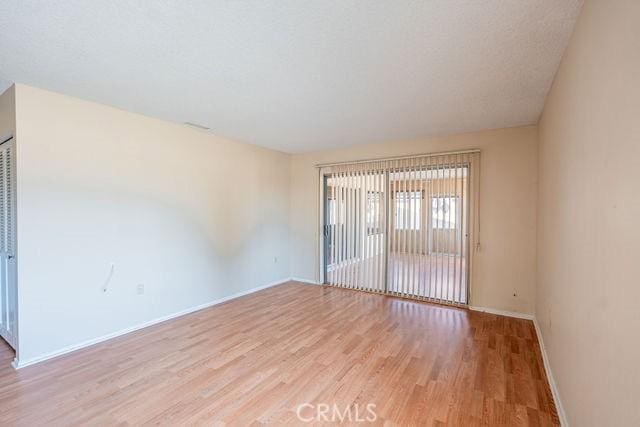 unfurnished room with light hardwood / wood-style flooring