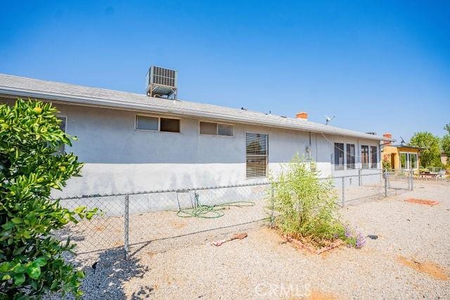 rear view of property featuring cooling unit