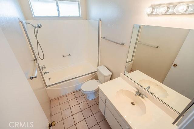 full bathroom with tile patterned flooring, vanity, combined bath / shower with glass door, and toilet