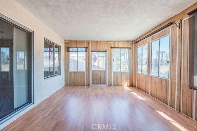 unfurnished sunroom featuring a wealth of natural light