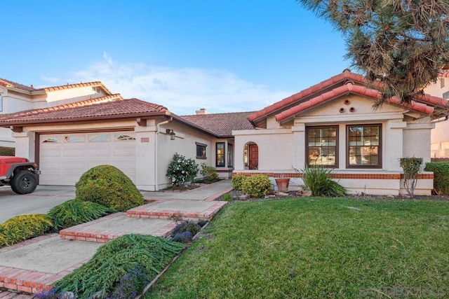 mediterranean / spanish house with a garage and a front yard