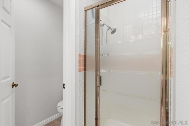 bathroom featuring toilet and walk in shower