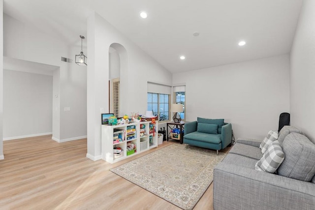 living room featuring hardwood / wood-style floors and high vaulted ceiling