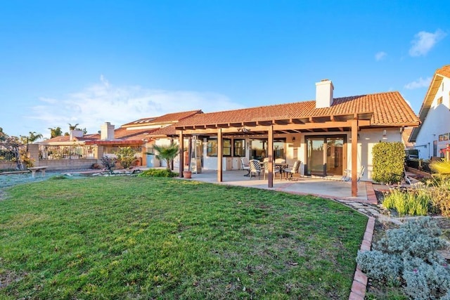 back of property featuring a lawn and a patio area