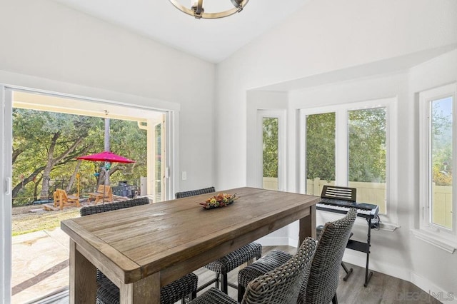 dining area featuring lofted ceiling, light hardwood / wood-style floors, and a wealth of natural light