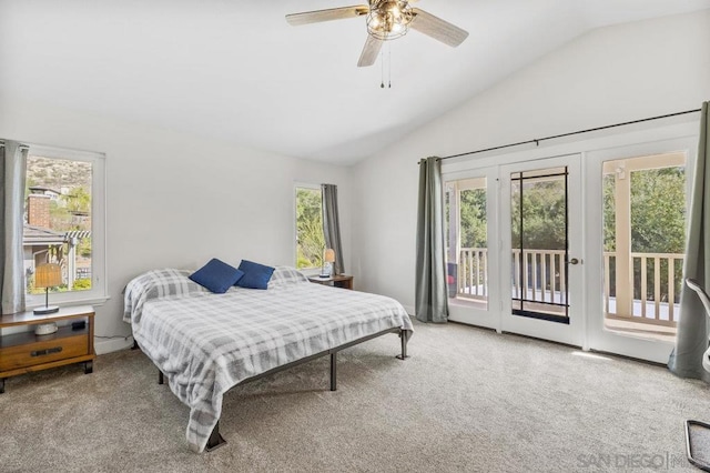 carpeted bedroom featuring vaulted ceiling, access to exterior, and ceiling fan