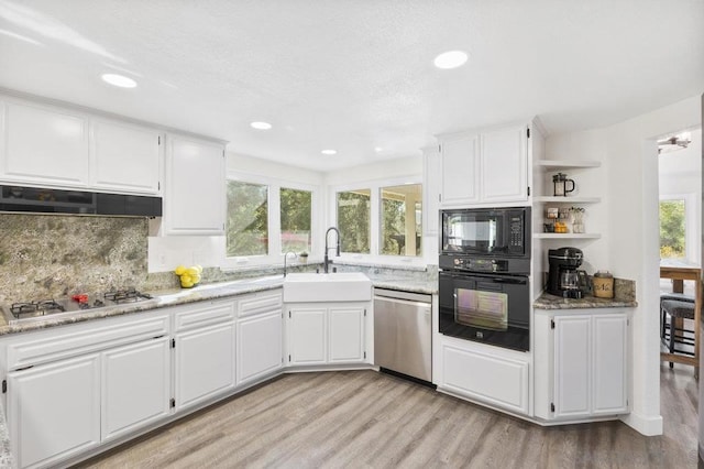 kitchen featuring sink, white cabinets, and black appliances