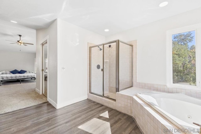 bathroom featuring hardwood / wood-style flooring and plus walk in shower