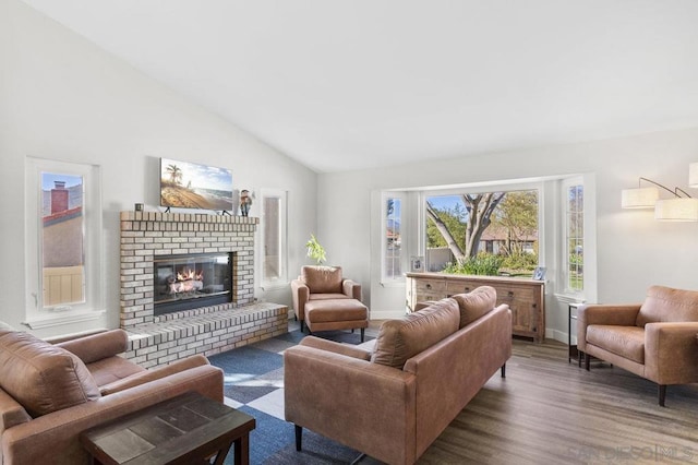 living room with a brick fireplace, dark hardwood / wood-style floors, and lofted ceiling