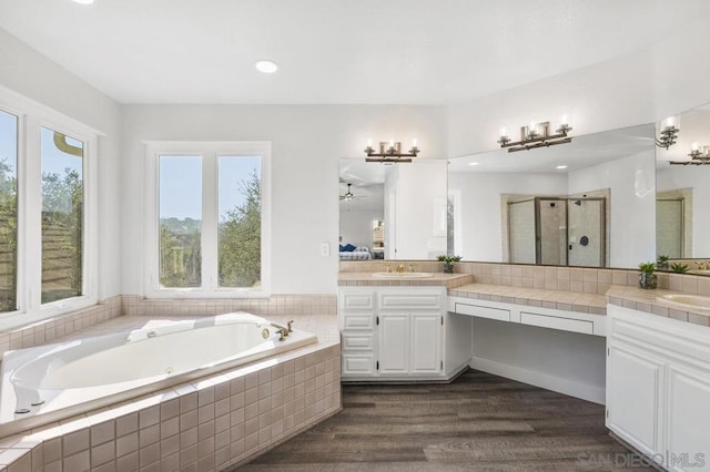 bathroom with vanity, hardwood / wood-style floors, and separate shower and tub