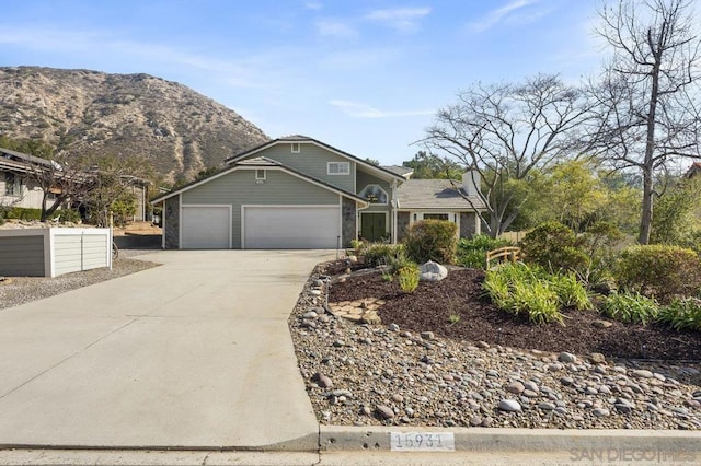 view of front facade featuring a mountain view and a garage