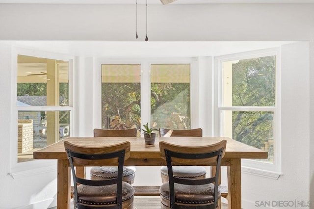 sunroom / solarium featuring ceiling fan