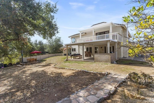 back of property featuring a patio area and a balcony