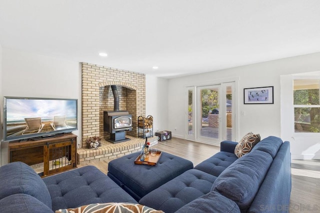 living room featuring light hardwood / wood-style flooring and a wood stove