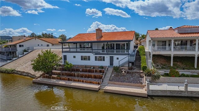 30567 Sea Horse Cir, Canyon Lake, CA 92587 - back of property with stairway, a chimney, fence, a balcony, and a water view