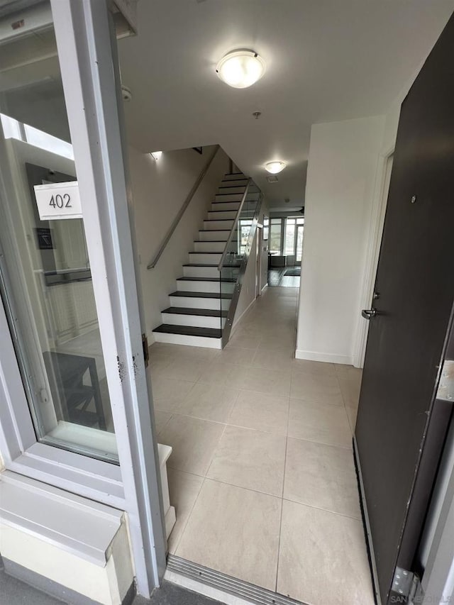 stairs featuring tile patterned flooring