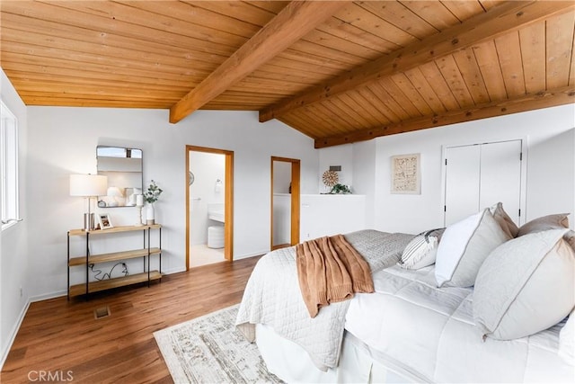 bedroom with vaulted ceiling with beams, hardwood / wood-style floors, wooden ceiling, and ensuite bath