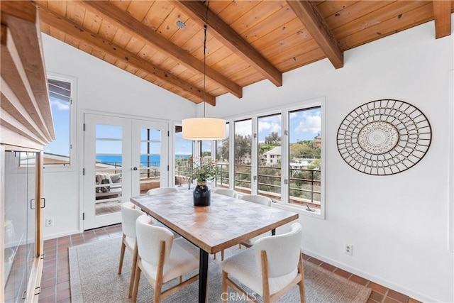 dining space with a water view, vaulted ceiling with beams, wooden ceiling, and french doors