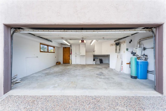 garage with a garage door opener and water heater