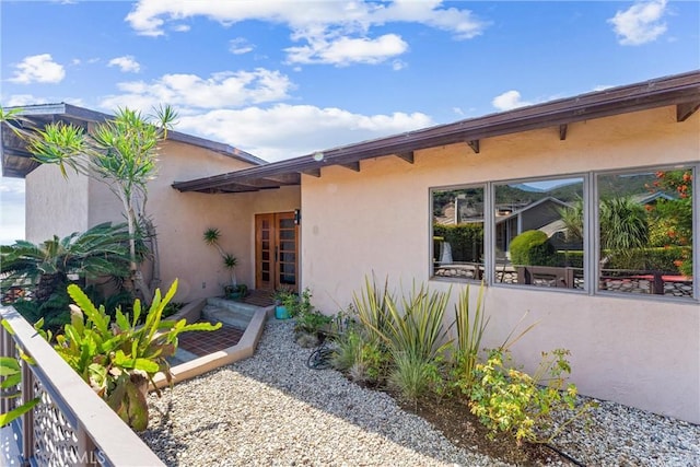 property entrance with stucco siding