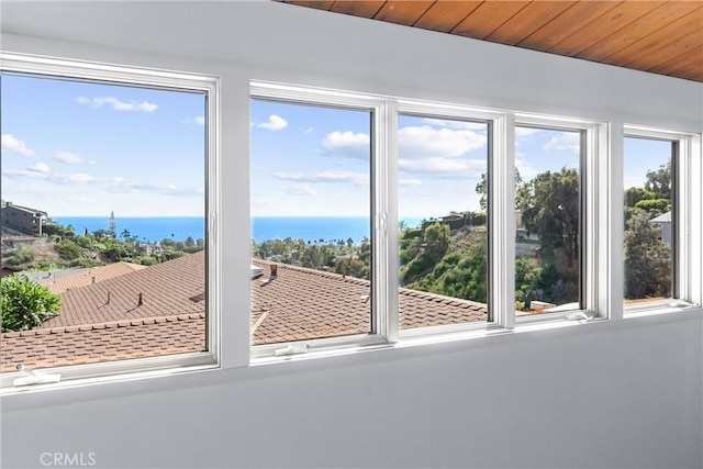 doorway to outside featuring wood ceiling, plenty of natural light, and a water view