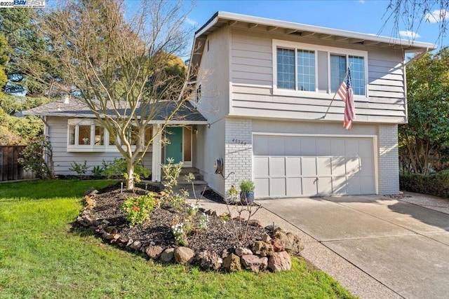 view of front of house featuring a garage and a front lawn