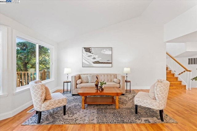 living room featuring vaulted ceiling and hardwood / wood-style floors