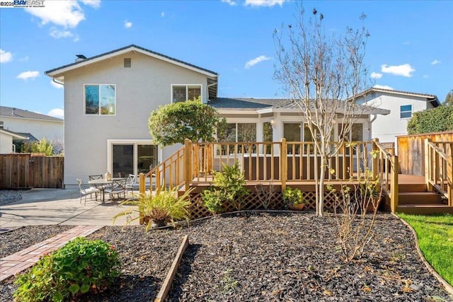 rear view of house with a deck and a patio