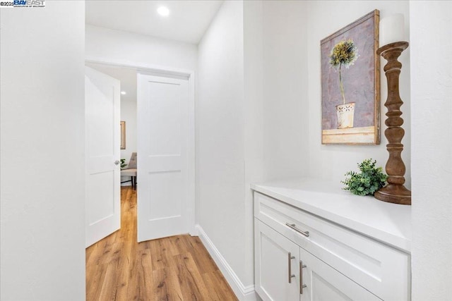 hall with light hardwood / wood-style floors