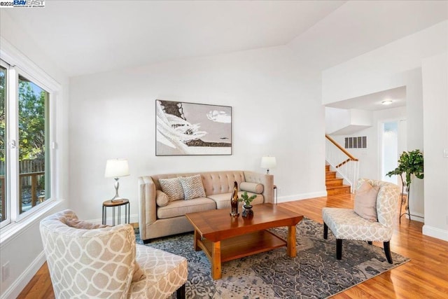 living room with lofted ceiling and hardwood / wood-style flooring