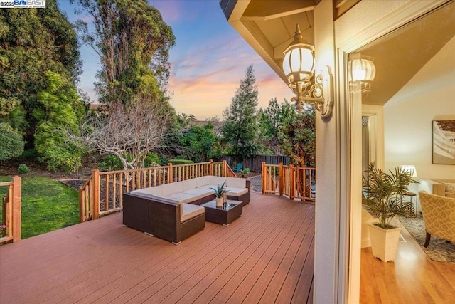 deck at dusk with an outdoor hangout area