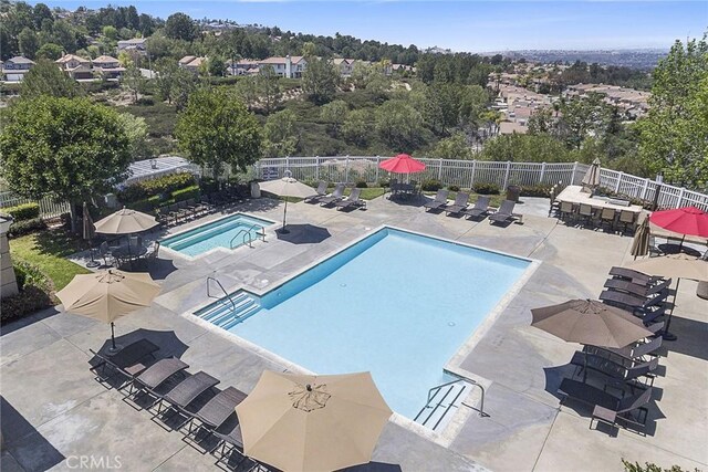 view of pool with a hot tub and a patio