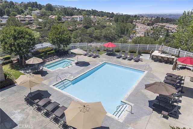 community pool featuring a patio area and fence