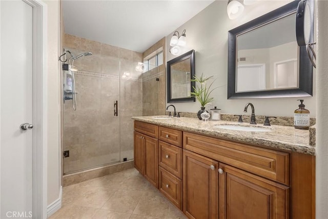 full bathroom with a sink, a stall shower, double vanity, and tile patterned floors