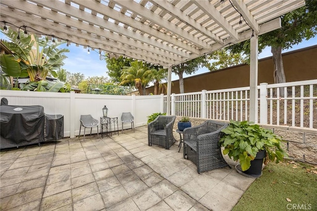 view of patio with grilling area, a pergola, and fence