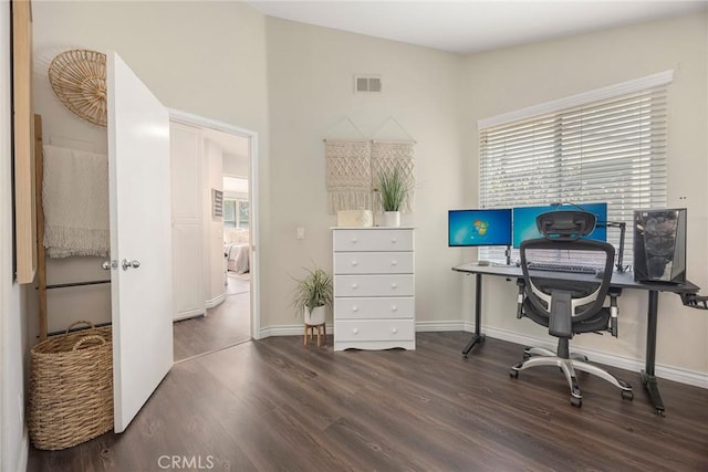 home office featuring visible vents, baseboards, and wood finished floors