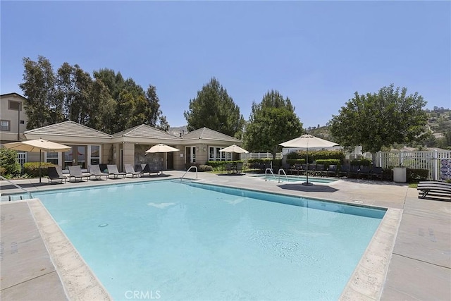 pool featuring a patio and fence