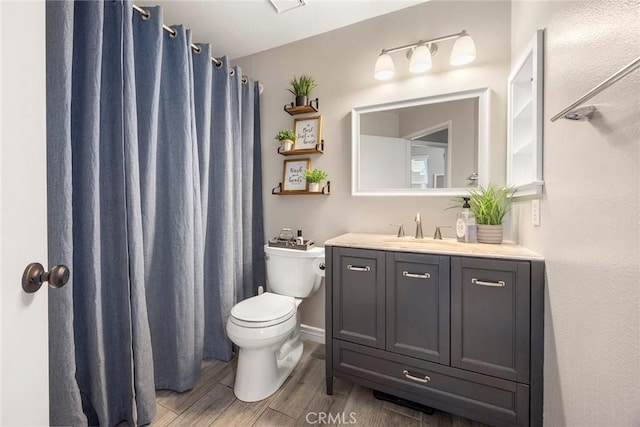 full bath with a shower with shower curtain, toilet, vanity, and wood finished floors