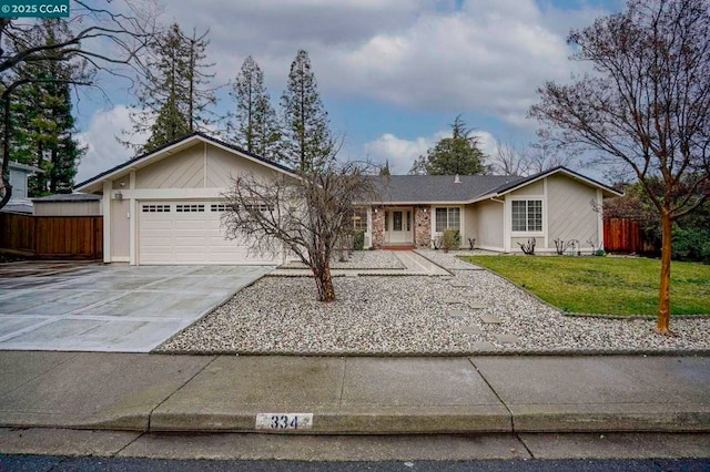 ranch-style house with a garage and a front yard